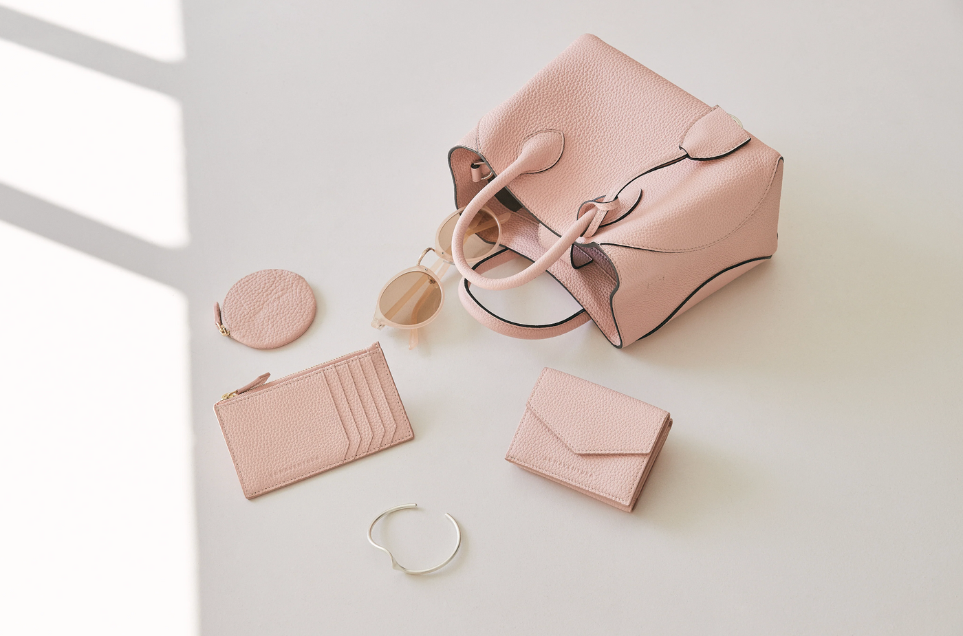 Pastel-colored leather handbags in spring decoration
